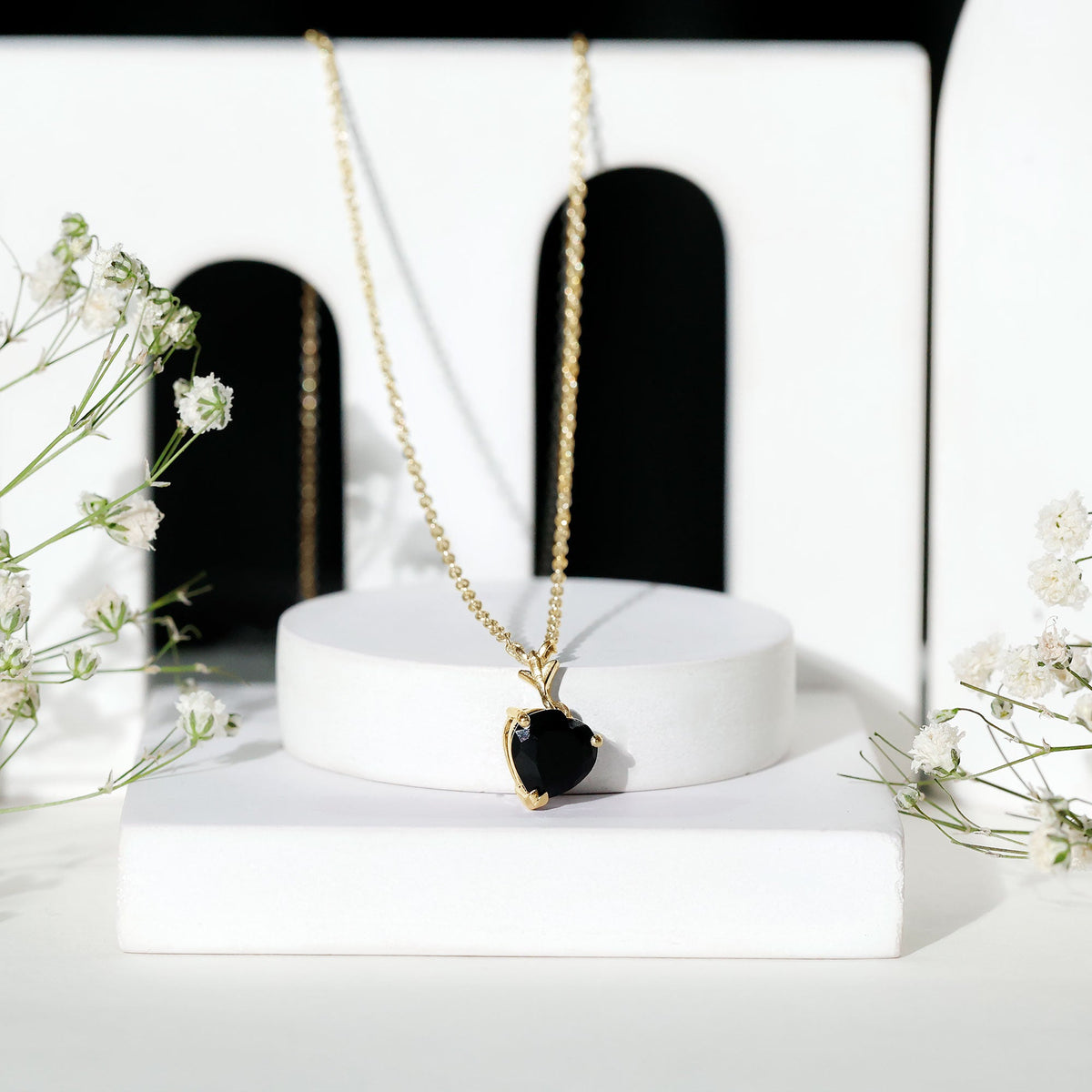 Heart-shaped black onyx solitaire pendant by Rosec Jewels, featuring a polished black gemstone on a delicate chain.