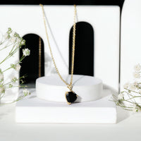 Heart-shaped black onyx solitaire pendant by Rosec Jewels, featuring a polished black gemstone on a delicate chain.