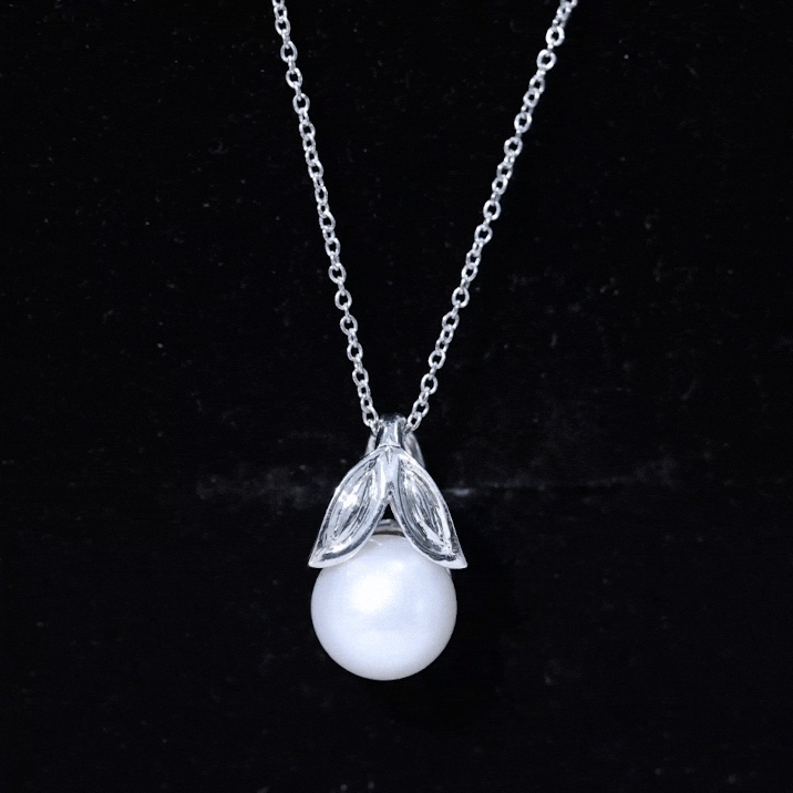 Freshwater pearl solitaire pendant with leaf design from Rosec Jewels, featuring a smooth pearl and delicate leaf motif.
