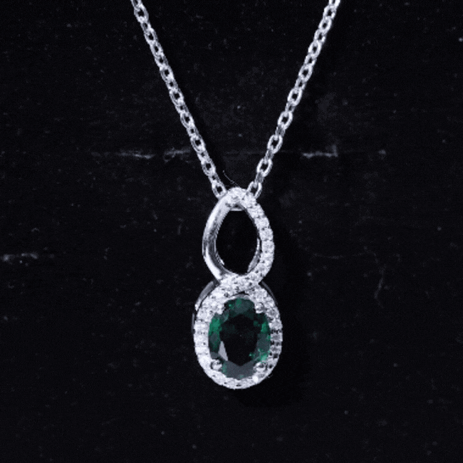 Oval lab-grown emerald infinity pendant necklace with silver chain, showcasing a 1.2 carat emerald gemstone from Rosec Jewels.