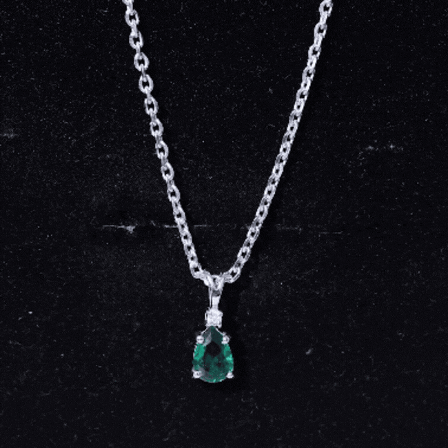 Lab grown 0.7 carat emerald teardrop pendant on silver chain by Rosec Jewels, showcasing a sparkling green gemstone.