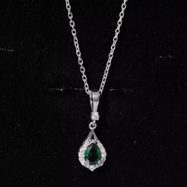 Lab grown 0.7 carat emerald pendant with chain from Rosec Jewels, featuring a sparkling green gemstone and elegant silver setting.