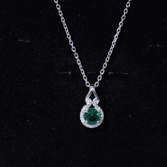 Lab grown emerald pendant necklace with moissanite halo, featuring a 0.8 carat emerald gemstone and elegant silver setting.