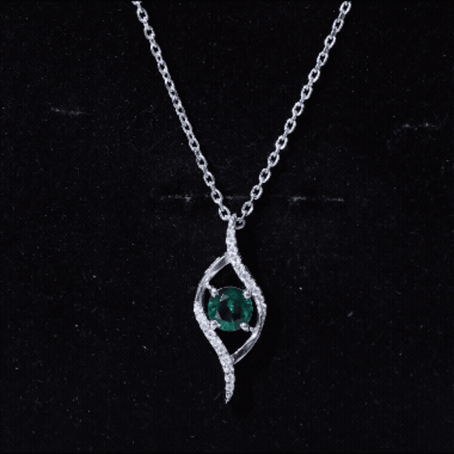 Lab grown emerald leaf pendant with silver chain, 0.8 carats, from Rosec Jewels, showcasing a detailed emerald leaf design.