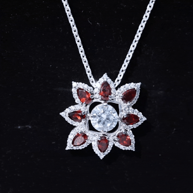 Yellow gold flower pendant with a certified lab-grown diamond and garnet accents, crafted by Rosec Jewels.