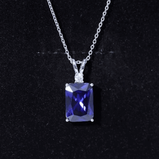 Emerald cut blue sapphire solitaire pendant with silver chain by Rosec Jewels, showcasing a 9-carat lab-grown sapphire.