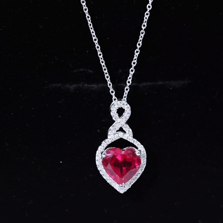 Lab-grown 2-carat ruby heart pendant on silver chain, elegant jewelry piece from Rosec Jewels, showcasing a sparkling infinity design.