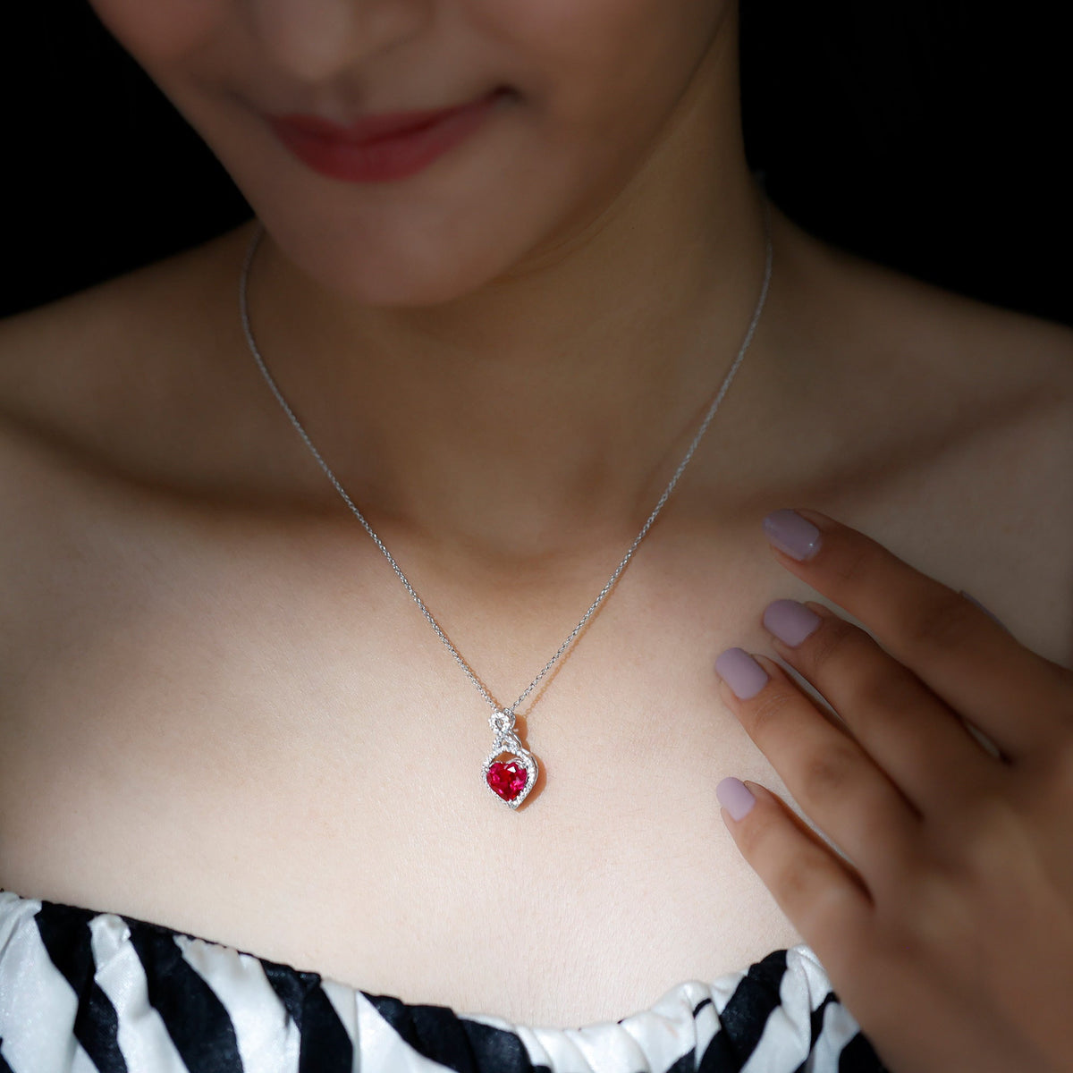 Lab-created ruby heart infinity pendant with chain by Rosec Jewels, showcasing a sparkling red gemstone on a delicate chain.