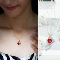 Rosec Jewels lab-created ruby heart infinity pendant with chain, showcasing a sparkling ruby heart and elegant jewelry design.