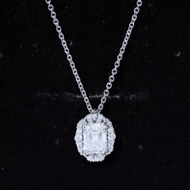 Yellow gold pendant with a 6x8 mm emerald cut lab-grown diamond and halo setting, featuring a Rosec Jewels statement necklace.