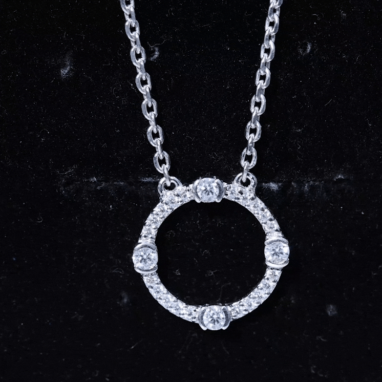 Yellow gold pendant featuring a lab-grown diamond half bezel set in an open circle design by Rosec Jewels.