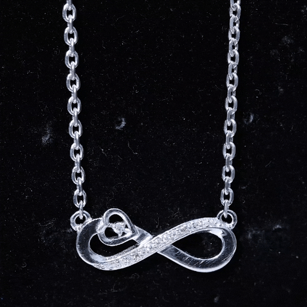 Yellow gold infinity heart pendant with lab-grown diamond, crafted by Rosec Jewels, showcasing elegant pendant design.