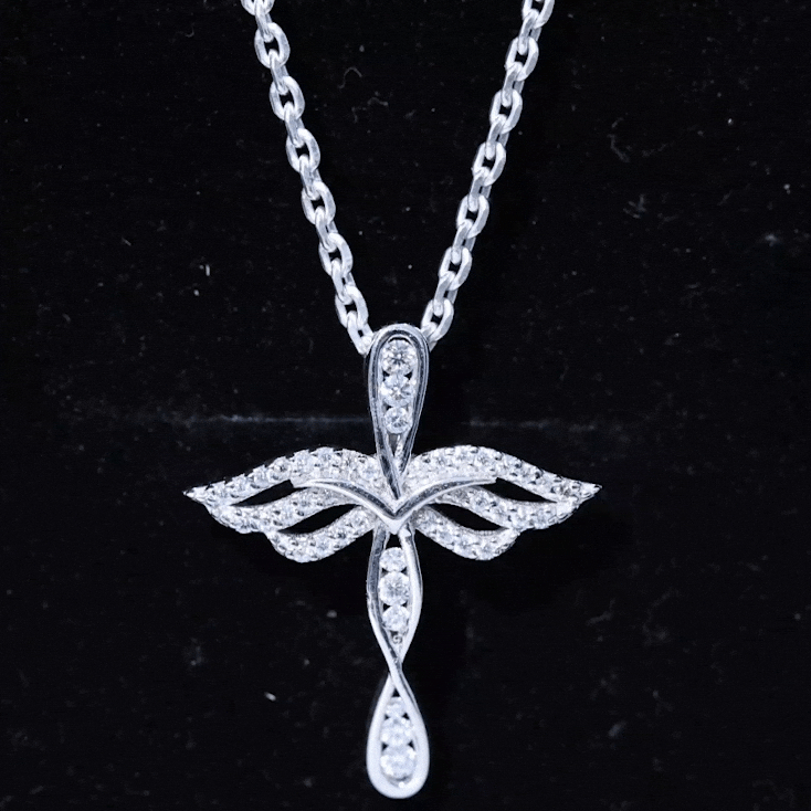 Yellow gold pendant featuring a cross angel design with lab-grown diamond accents, prong set, from Rosec Jewels.
