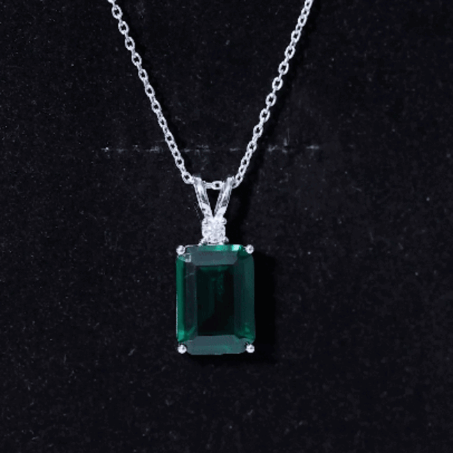 Lab grown 8 carat emerald solitaire pendant on silver chain by Rosec Jewels, showcasing the vibrant green gemstone.