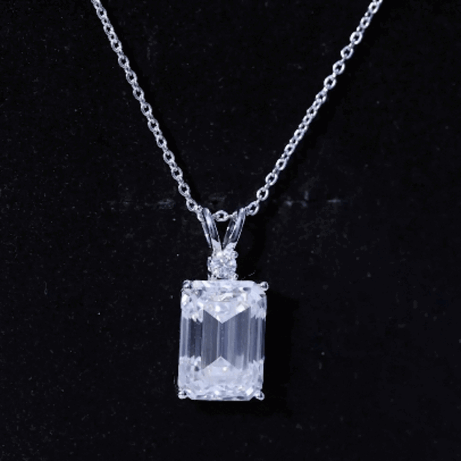 Elegant 4.5 carat moissanite emerald cut pendant on silver chain from Rosec Jewels, showcasing sparkling gemstone and sleek design.