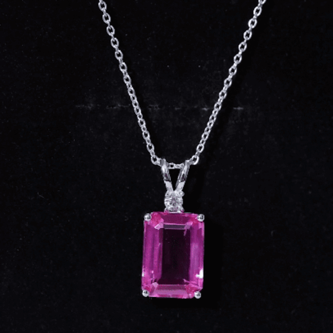 Lab-grown pink sapphire pendant with emerald cut on silver chain, featuring a 9-carat gemstone from Rosec Jewels.