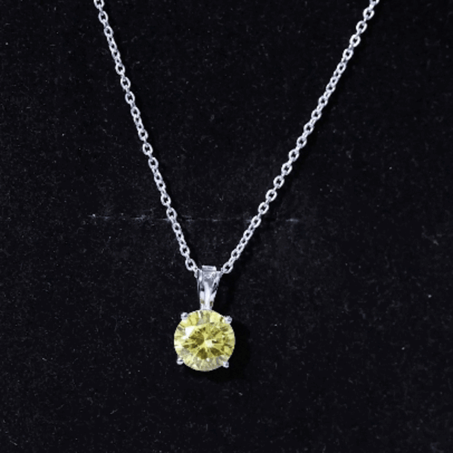 Lab grown yellow sapphire solitaire pendant on silver chain, showcasing the elegant 2-carat gemstone design.