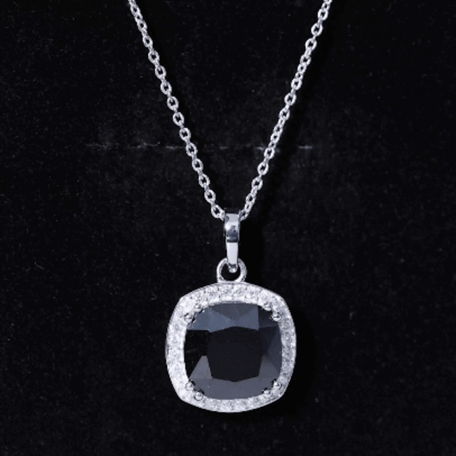 Cushion cut lab grown black diamond pendant with halo setting on silver chain, designed by Rosec Jewels.