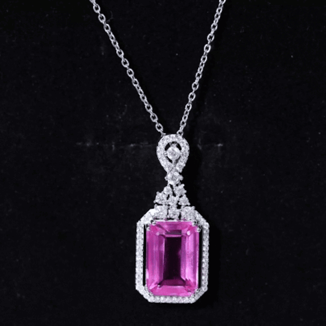 Pink sapphire Art Deco pendant on silver chain, 9 carats, from Rosec Jewels, showcasing intricate design and vibrant gemstone details.