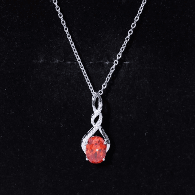 Orange sapphire infinity pendant necklace with lab-grown gemstone and moissanite accents, showcasing elegant jewelry design.