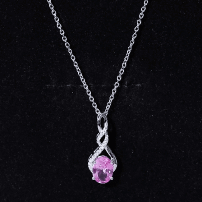 Lab grown pink sapphire infinity pendant on silver chain, elegant jewelry from Rosec Jewels with 1.5 carat pink sapphire.