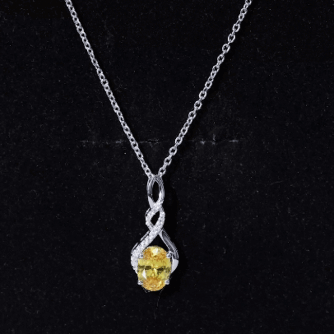 Lab-grown 1.5 carat yellow sapphire infinity pendant on silver chain, featuring a sparkling yellow gemstone and elegant silver setting.