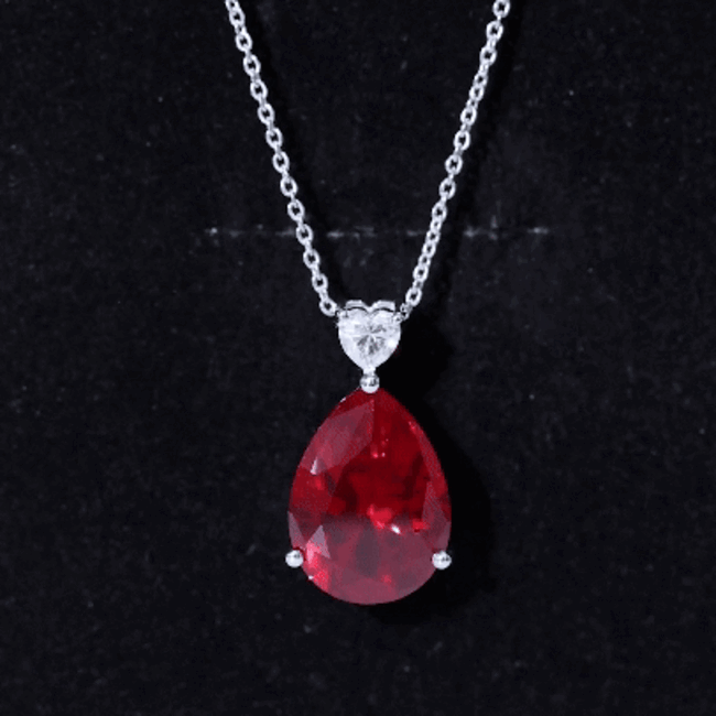 Lab-grown 9 carat ruby teardrop pendant with heart-shaped moissanite, set in a elegant jewelry pendant.