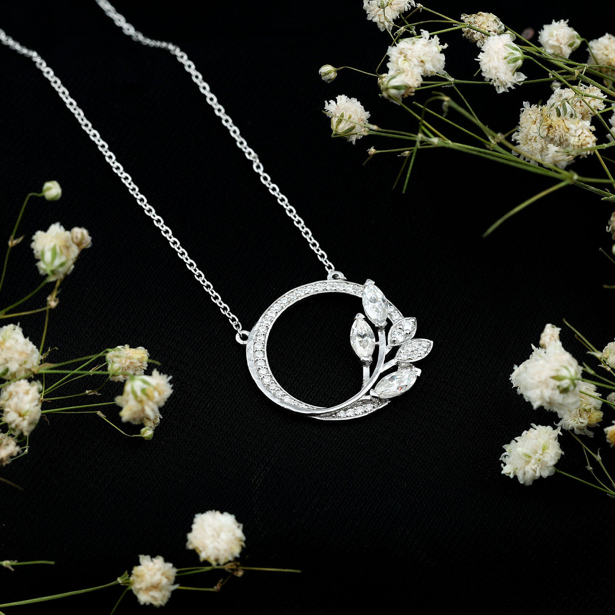 Marquise and round cut moissanite leaf pendant necklace with intricate design, showcasing sparkling gemstones and elegant craftsmanship.