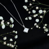 Diagonal set of three 3-carat cubic zirconia princess cut pendants with chain by Rosec Jewels displayed on a white background.