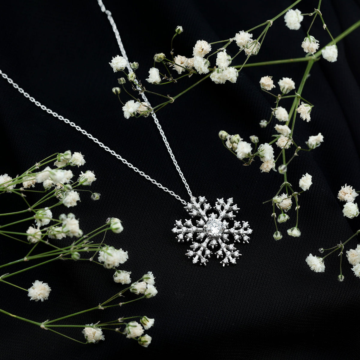 Silver chain pendant with cubic zirconia snowflake design from Rosec Jewels, showcasing a sparkling snowflake-shaped pendant.