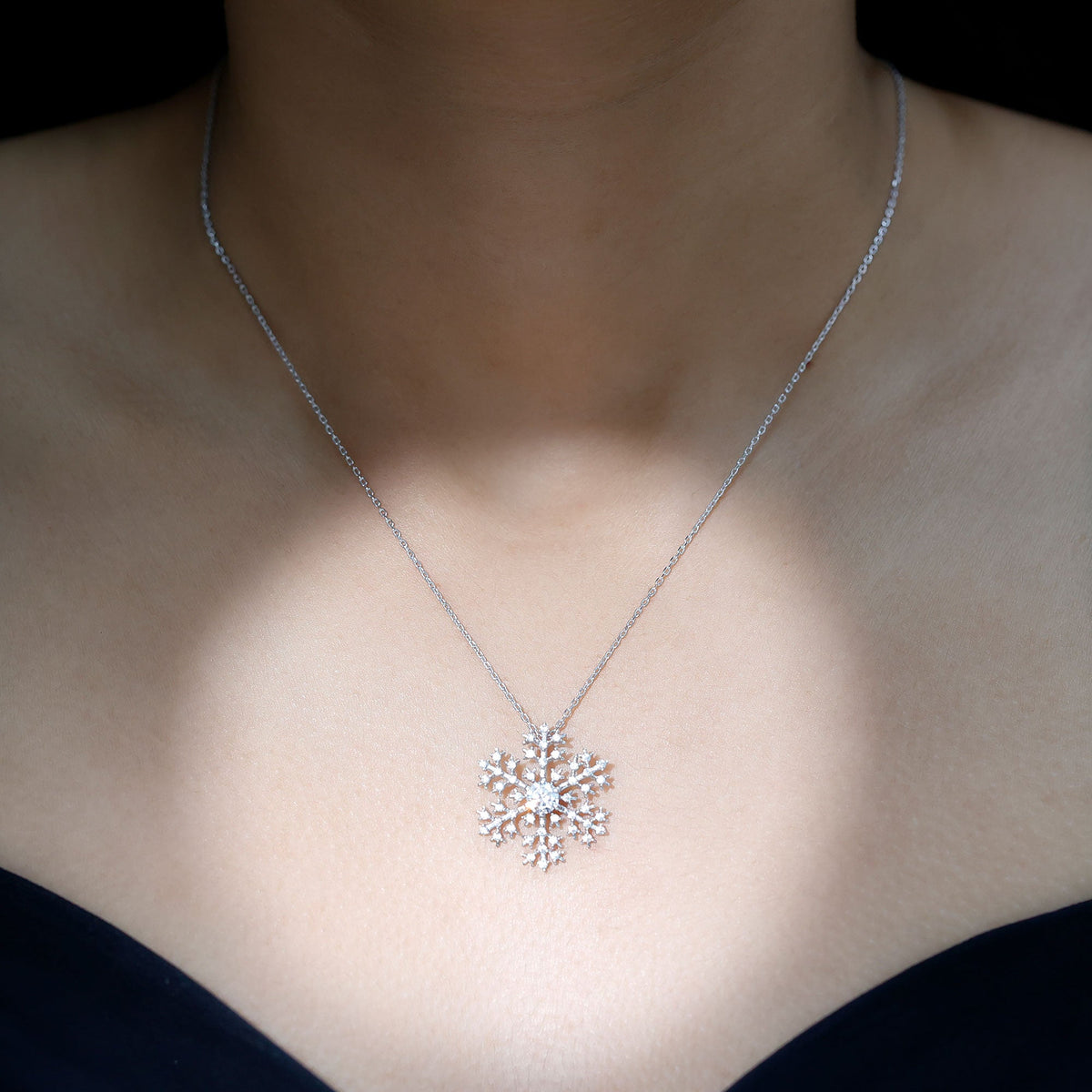 Cubic zirconia snowflake pendant with silver chain from Rosec Jewels, showcasing sparkling snowflake design on a silver necklace.