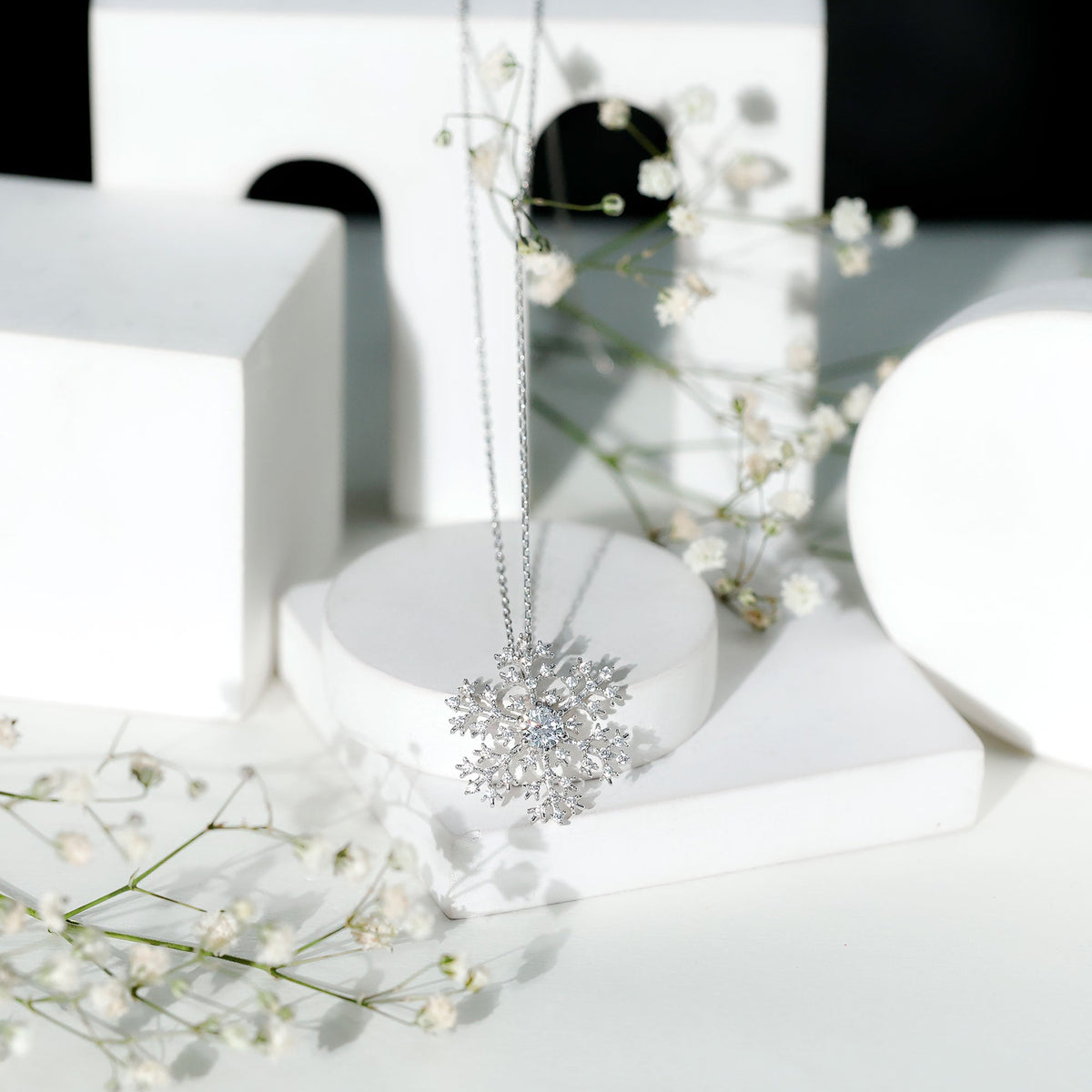 Silver chain pendant featuring a cubic zirconia snowflake design from Rosec Jewels, showcasing intricate sparkle and winter-inspired elegance.