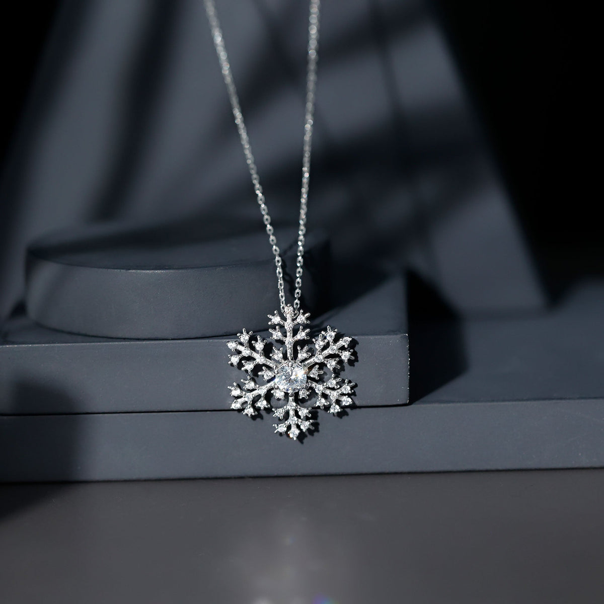 Silver chain necklace with a cubic zirconia snowflake pendant, elegant jewelry from Rosec Jewels.