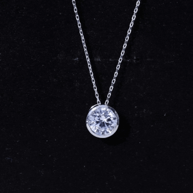 Bezel set cubic zirconia solitaire pendant on silver chain by Rosec Jewels, featuring a sparkling white cubic zirconia gemstone.