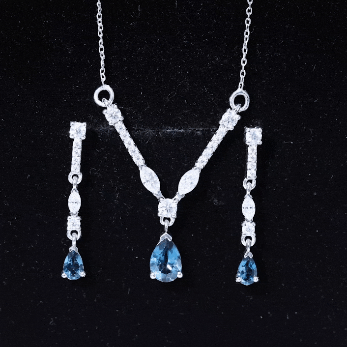 Pear-shaped London Blue Topaz and Moissanite jewelry set with matching necklace and earrings by Rosec Jewels