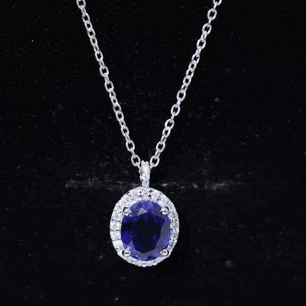 Oval lab-grown blue sapphire pendant from Rosec Jewels on a silver chain, showcasing a sparkling 4-carat gemstone for bridal jewelry.