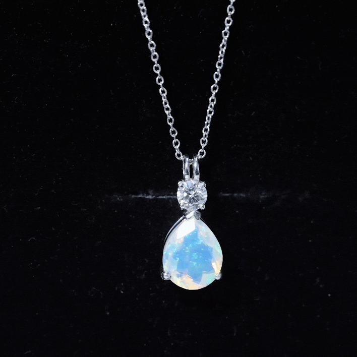 Pear-shaped rainbow opal teardrop pendant with moissanite, featuring an 8x10mm gemstone set in a Rosec Jewels jewelry pendant.