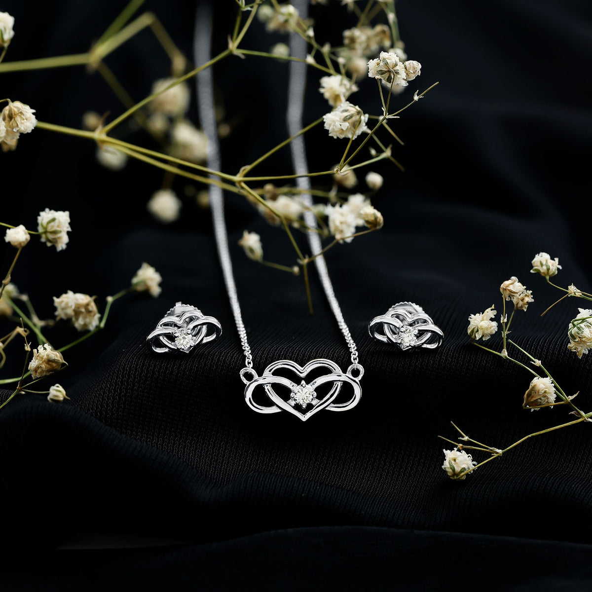 Round cut diamond infinity and heart jewelry set by Rosec Jewels, featuring sparkling diamond accents and elegant design.