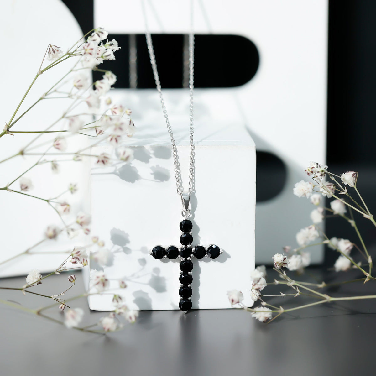 Natural black onyx cross pendant necklace for women by Rosec Jewels, showcasing a sleek black onyx cross on a delicate chain.