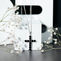 Natural black onyx cross pendant necklace for women by Rosec Jewels, showcasing a sleek black onyx cross on a delicate chain.