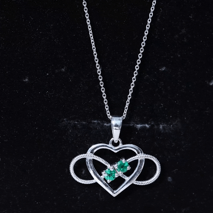 Heart infinity pendant necklace with a real emerald from Rosec Jewels, featuring a delicate silver chain and a sparkling heart-shaped design.