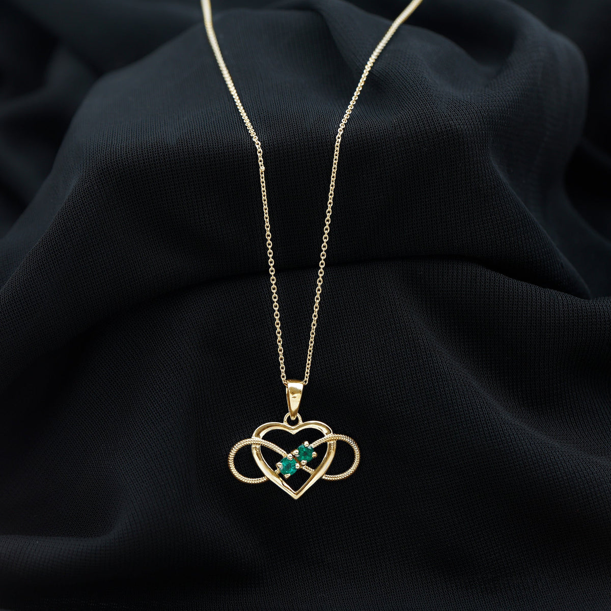 Heart infinity pendant necklace by Rosec Jewels featuring a real emerald gemstone on a delicate chain.