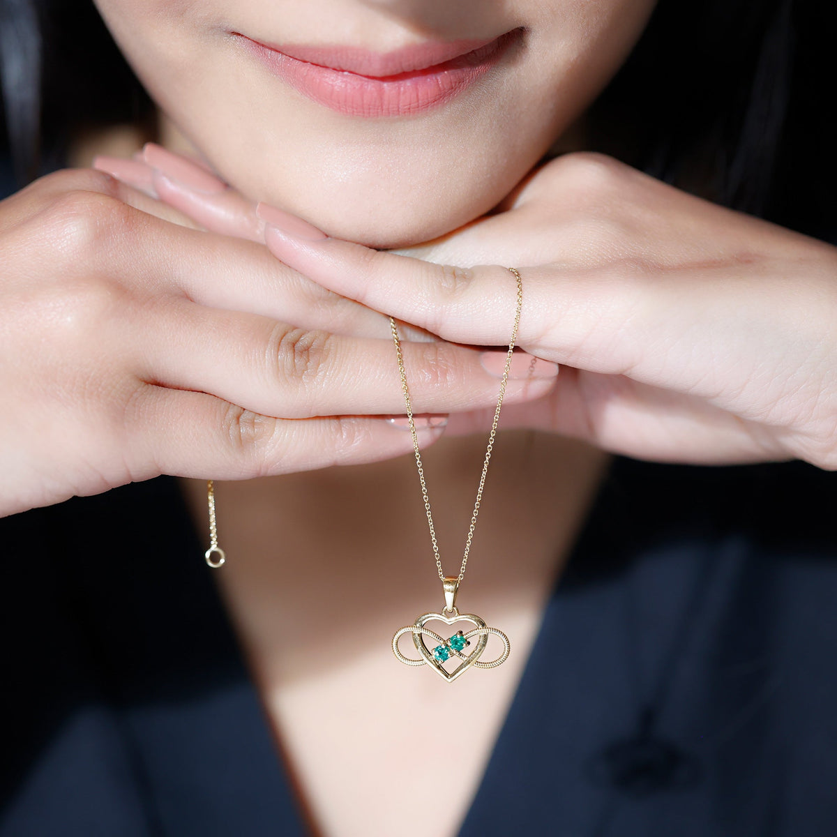 Heart infinity pendant necklace with real emerald from Rosec Jewels featuring a silver chain and elegant design.