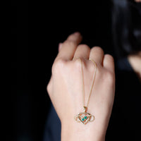 Heart infinity necklace pendant with real emerald by Rosec Jewels, featuring a delicate gold chain and sparkling green gemstone.