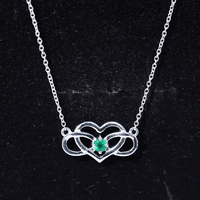Emerald heart and infinity pendant necklace for women by Rosec Jewels, featuring a delicate chain with green and silver accents.