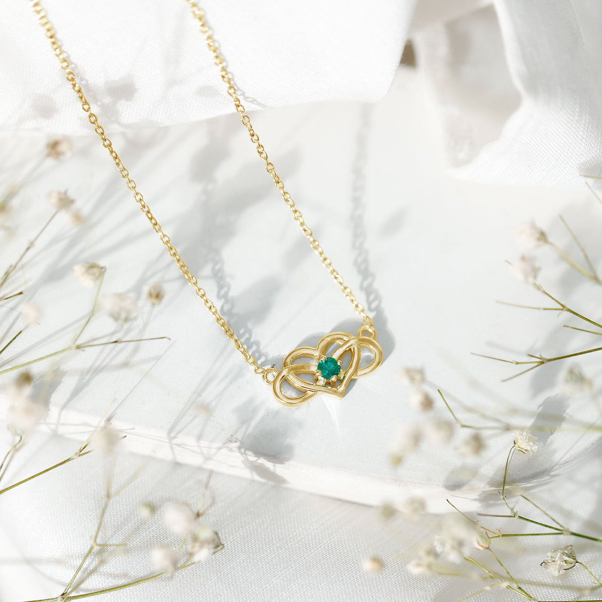 Emerald heart and infinity pendant necklace for women by Rosec Jewels featuring a silver chain and green gemstone accents.