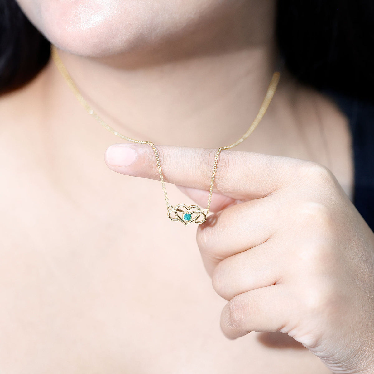 Emerald heart and infinity pendant necklace for women by Rosec Jewels, featuring a silver chain with green gemstone accents.