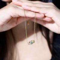 Emerald heart and infinity pendant necklace for women with gold chain, designed by Rosec Jewels.