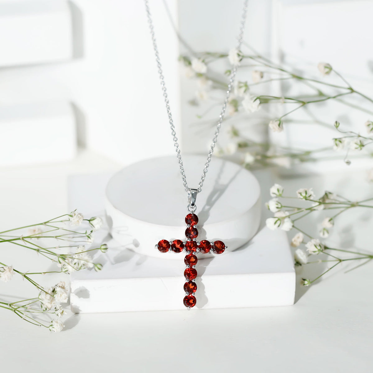 Genuine garnet cross pendant necklace from Rosec Jewels featuring a red gemstone in a silver setting.