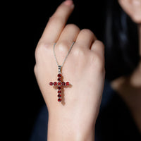 Genuine garnet cross pendant necklace with silver chain from Rosec Jewels, showcasing a detailed cross with deep red garnet stones.